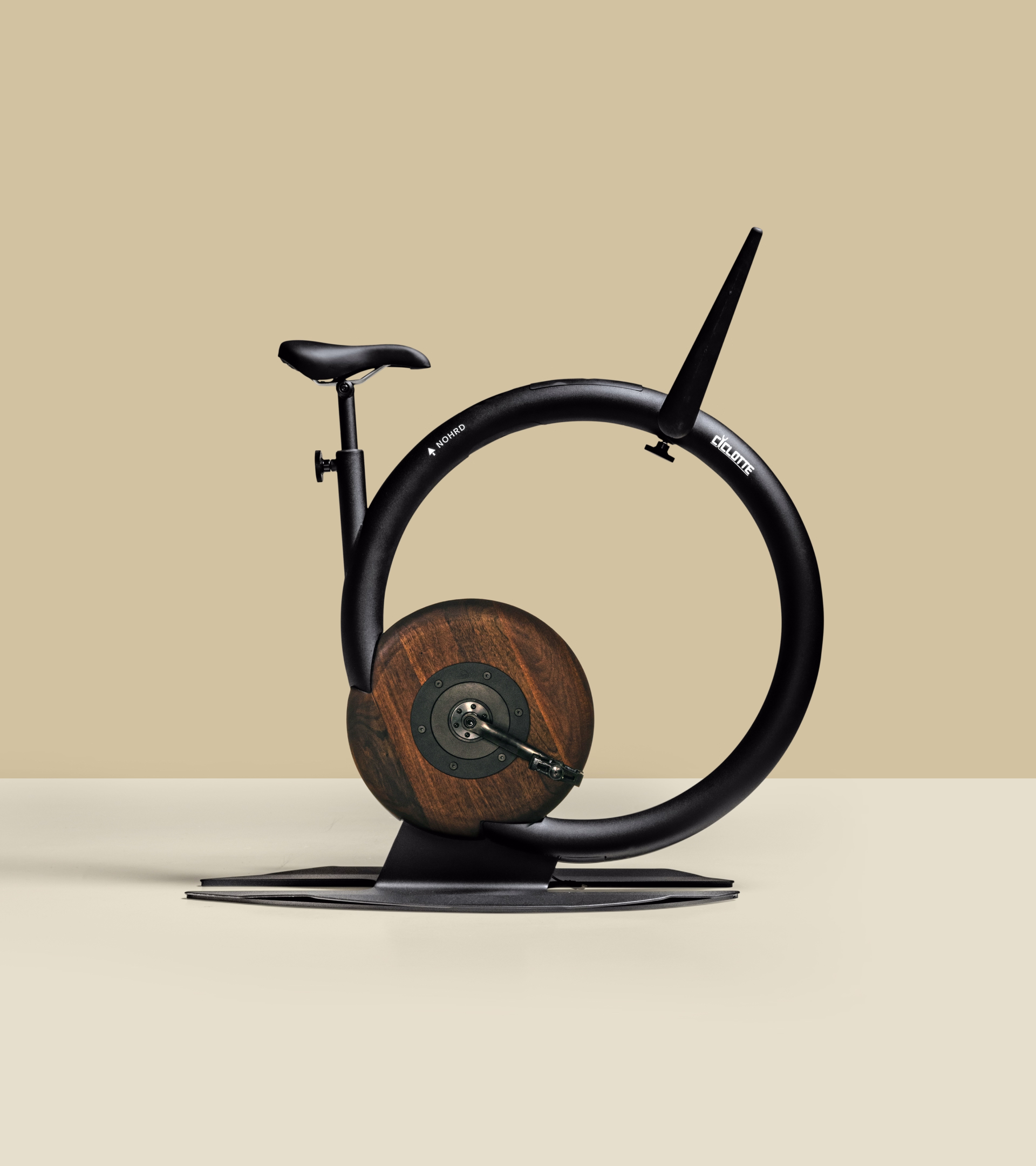 The Nohrd designer exercise bike by Ciclotte: a black ring frame with a solid walnut gearbox disc at its centre